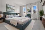 Step into this serene bedroom, featuring a plush, tufted headboard and a calming color palette.