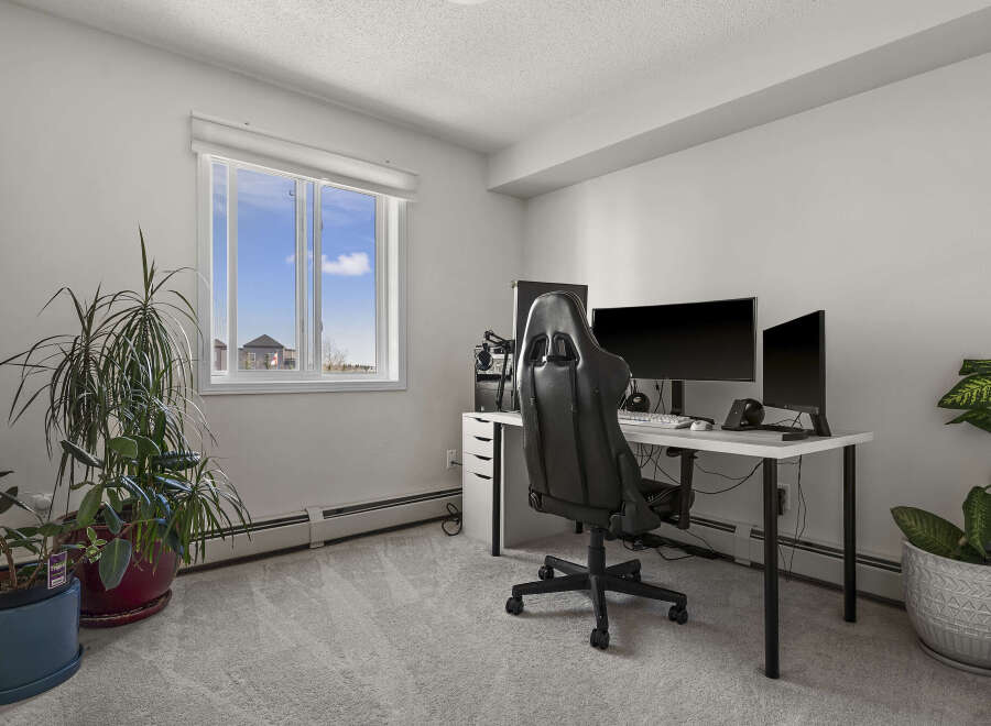 This bright and airy home office features a modern desk setup, perfect for productivity.