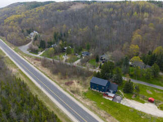 Discover a stunning property nestled in a serene, wooded landscape.