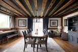 Step into luxury with this stunning dining room, featuring a rustic beamed ceiling and elegant furnishings.
