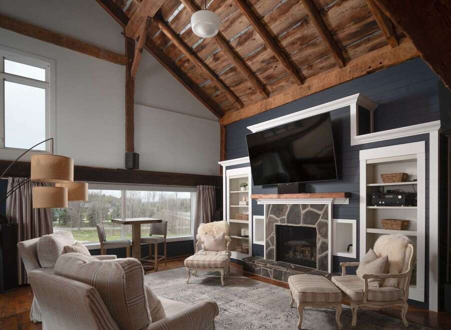Experience luxury living in this stunning property featuring a cozy fireplace and a large flat-screen TV, perfect for entertaining.
