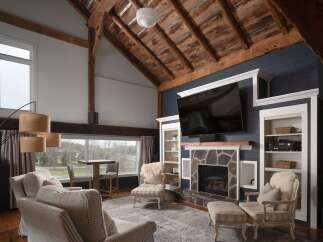 Experience luxury living in this stunning property featuring a cozy fireplace and a large flat-screen TV, perfect for entertaining.