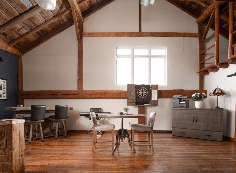 This stunning property boasts a rustic, open-concept design with exposed wooden beams and a warm, inviting atmosphere.