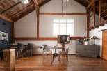 This stunning property boasts a rustic, open-concept design with exposed wooden beams and a warm, inviting atmosphere.