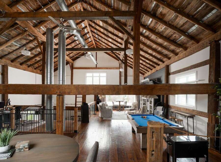 Experience rustic elegance in this stunning property featuring exposed wooden beams and a soaring vaulted ceiling.