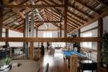 Experience rustic elegance in this stunning property featuring exposed wooden beams and a soaring vaulted ceiling.