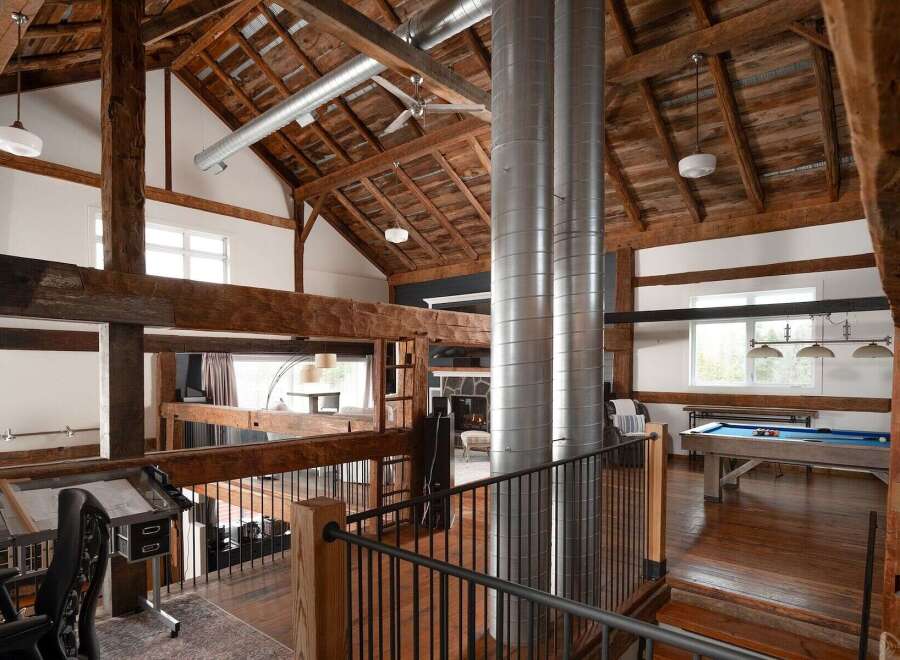 Experience rustic elegance in this stunning property featuring exposed wooden beams and a high, vaulted ceiling.