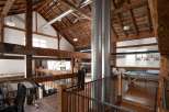 Experience rustic elegance in this stunning property featuring exposed wooden beams and a high, vaulted ceiling.