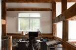 This stunning property boasts a unique, rustic design with exposed wooden beams and a loft-style workspace.