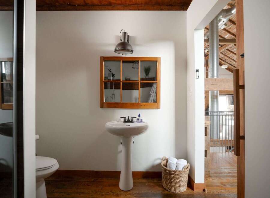 This stunning bathroom boasts a unique blend of rustic charm and modern design.