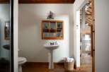 This stunning bathroom boasts a unique blend of rustic charm and modern design.