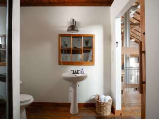 This stunning bathroom boasts a unique blend of rustic charm and modern design.