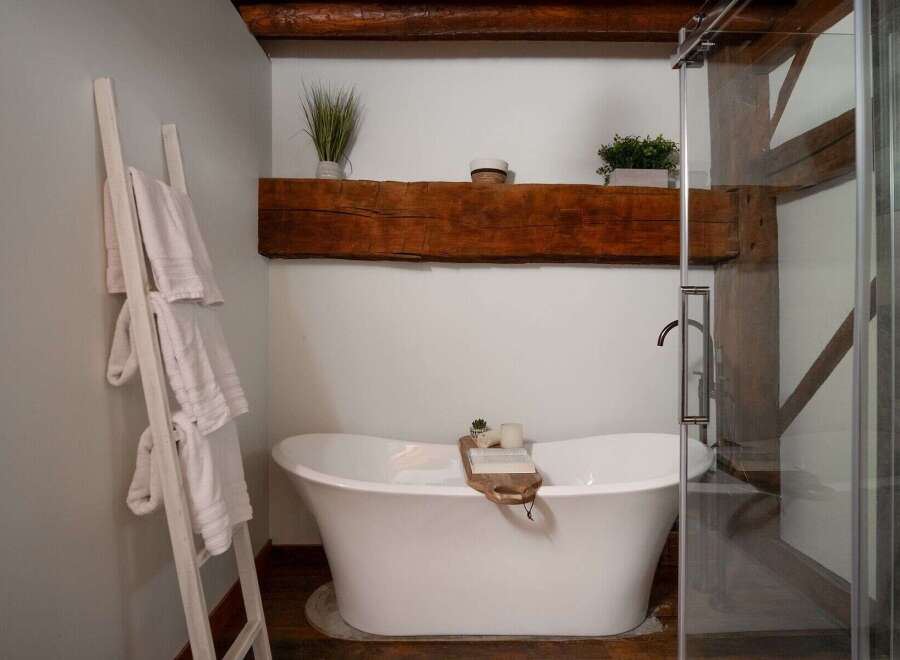 Indulge in the luxury of this stunning bathroom, featuring a freestanding bathtub and a spa-like ambiance.
