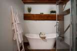 Indulge in the luxury of this stunning bathroom, featuring a freestanding bathtub and a spa-like ambiance.