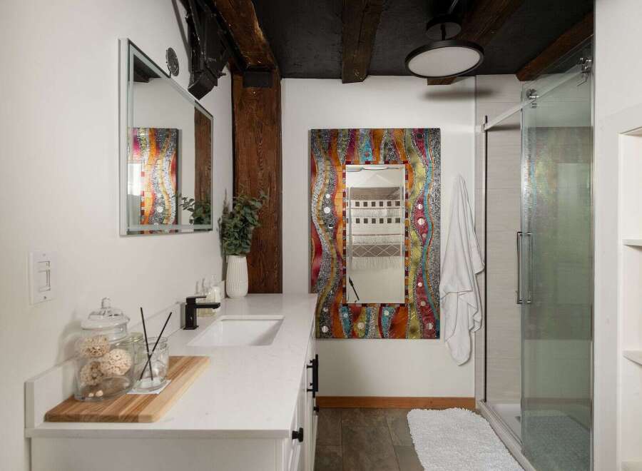 Step into a bathroom oasis with this stunning property! Featuring a unique, colorful mosaic mirror, this space exudes artistic charm.
