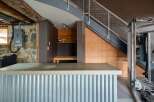 Discover the unique charm of this property, featuring a stylish corrugated metal bar and a functional home gym.