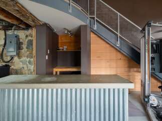 Discover the unique charm of this property, featuring a stylish corrugated metal bar and a functional home gym.