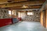 Discover the rustic charm of this unique property, featuring exposed wooden beams and stone walls.