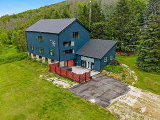 Discover this stunning modern home nestled amidst lush greenery and rolling hills.