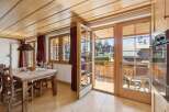 Step into this charming property featuring a warm and inviting dining area with a rustic wooden table and chairs.