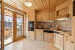 This charming kitchen boasts a warm, inviting atmosphere with its wooden cabinetry and flooring.