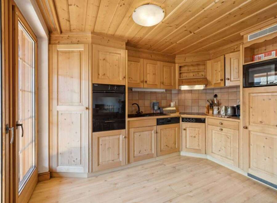 This stunning kitchen boasts a warm and inviting atmosphere with its natural wood finishes.