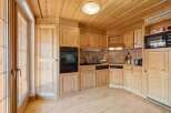 This stunning kitchen boasts a warm and inviting atmosphere with its natural wood finishes.