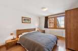 This cozy bedroom features a comfortable bed with a stylish quilt, perfect for a relaxing retreat.