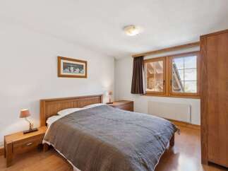 This cozy bedroom features a comfortable bed with a stylish quilt, perfect for a relaxing retreat.