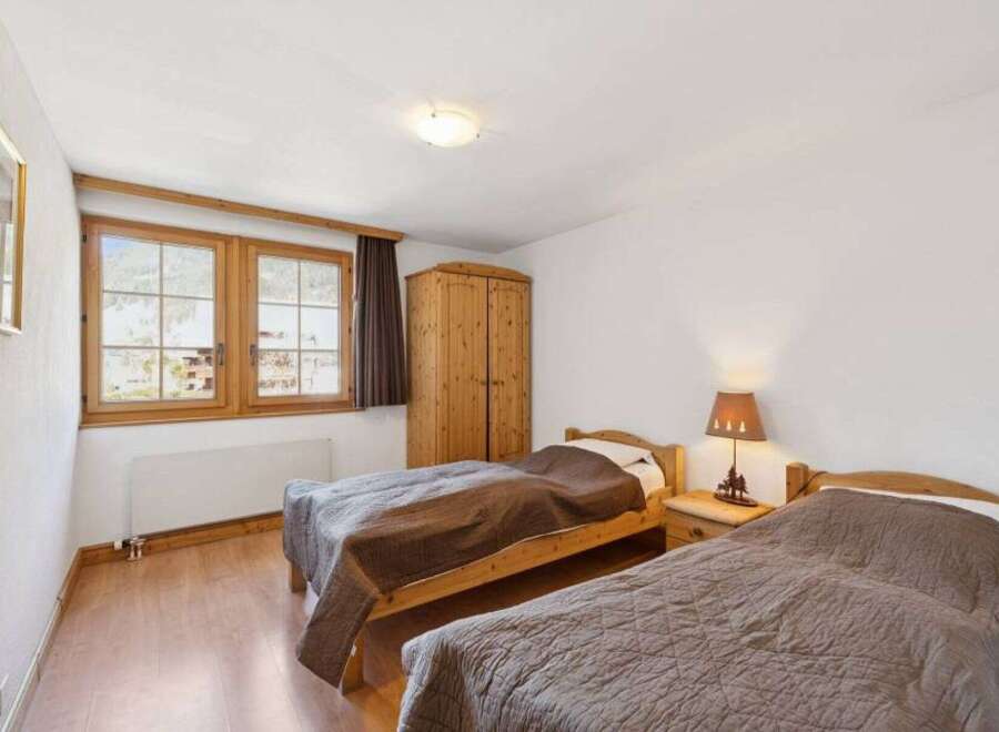 This charming bedroom features two cozy beds, perfect for a comfortable stay.