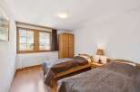This charming bedroom features two cozy beds, perfect for a comfortable stay.