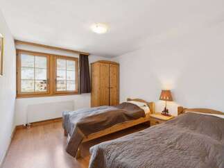This charming bedroom features two cozy beds, perfect for a comfortable stay.