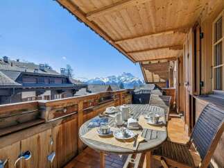 Enjoy breathtaking mountain views from this charming balcony.