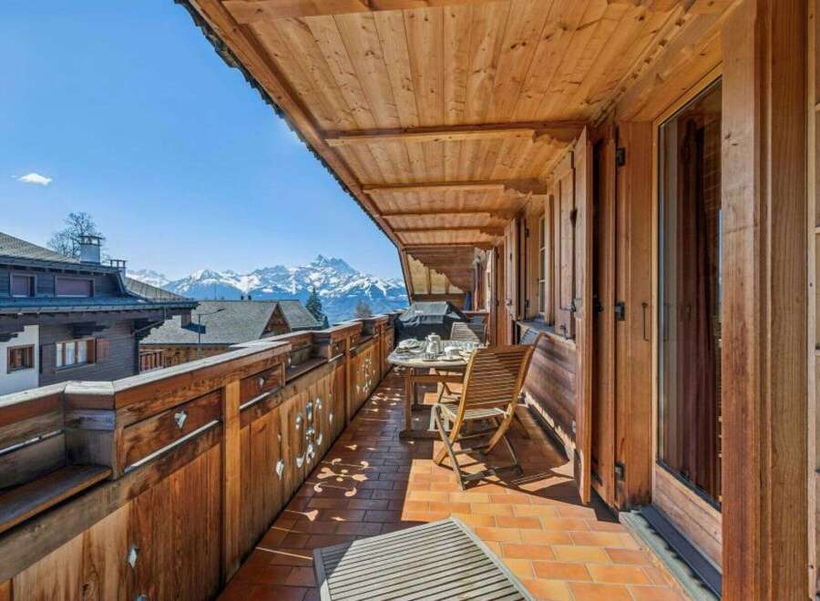 Enjoy breathtaking mountain views from this charming balcony.