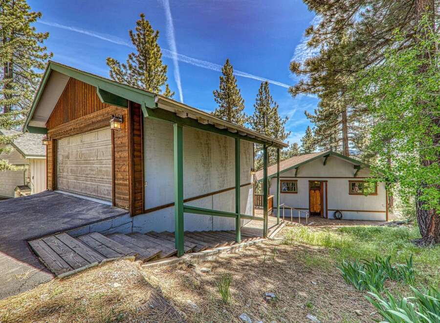 Nestled amidst towering trees, this charming property offers a serene escape.