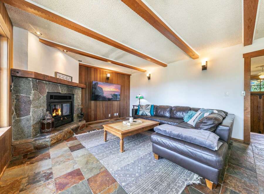 Step into luxury with this stunning living room featuring a cozy fireplace and a sleek, modern design.