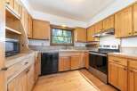 Step into this inviting kitchen, featuring warm wooden cabinetry and a functional layout.