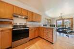 This stunning kitchen boasts beautiful wooden cabinetry and modern stainless steel appliances, creating a warm and inviting atmosphere.