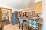 Step into this inviting kitchen, featuring a stainless steel refrigerator and ample cabinet space.
