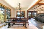 This stunning property features a spacious dining area with a beautiful wooden table and bench, perfect for family gatherings.