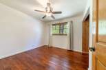 Step into this inviting room featuring beautiful hardwood floors and a stylish ceiling fan.