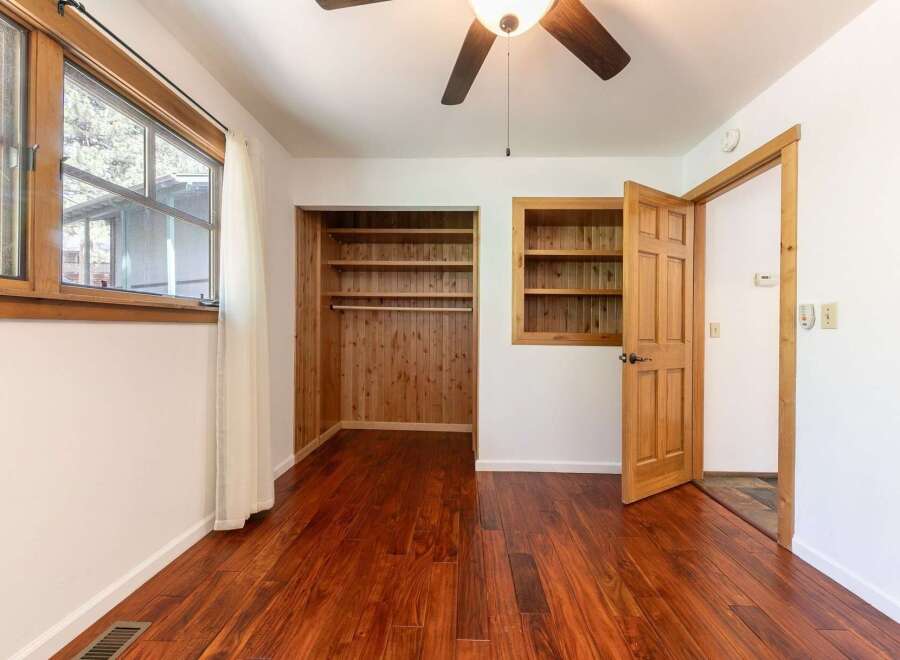 Step into this inviting bedroom featuring beautiful hardwood floors and ample natural light.