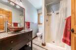 This stunning bathroom features a unique vessel sink and a stylish vanity, creating a focal point of elegance.