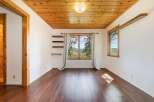 This stunning property boasts a warm and inviting interior with beautiful wood flooring and a charming wooden ceiling.