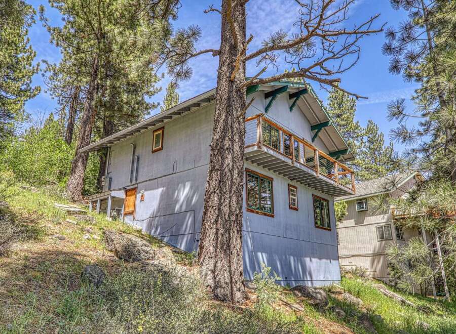Nestled amidst towering trees, this charming property offers a serene escape.