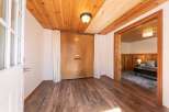 Step into this inviting space with stunning wood flooring and a warm, natural wood ceiling.