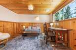 This cozy living space features a warm, inviting atmosphere with its wood-paneled walls and ceiling.