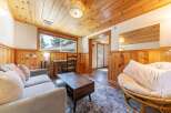 Step into this cozy cabin retreat, featuring a warm and inviting interior with wood paneling and a charming ambiance.