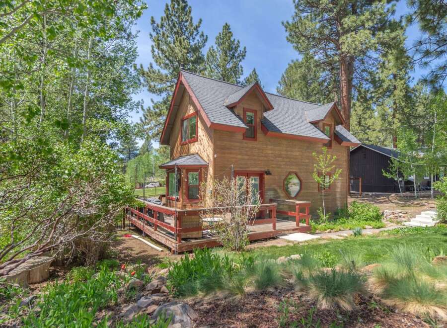 Nestled amidst lush greenery, this charming wooden cabin offers a serene retreat.