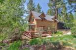 Nestled amidst lush greenery, this charming wooden cabin offers a serene retreat.